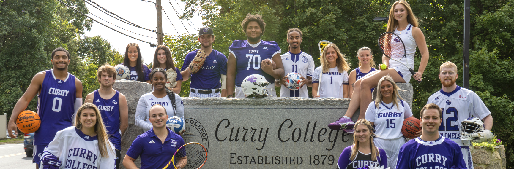 Ƶ student-athletes from every sport pose for a photo at the front gate of campus